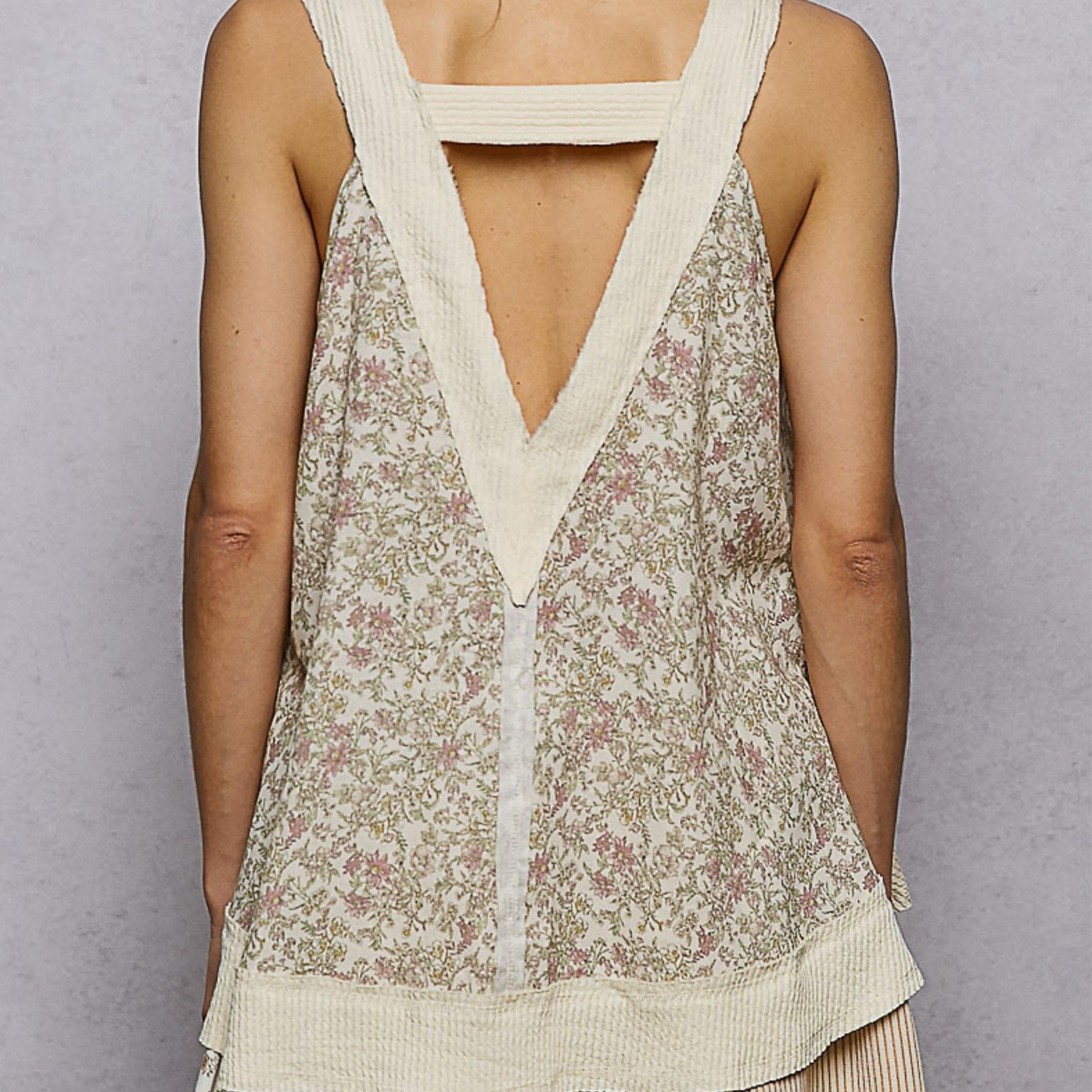 Back view of the POL floral tank showing the relaxed fit and curved hem.