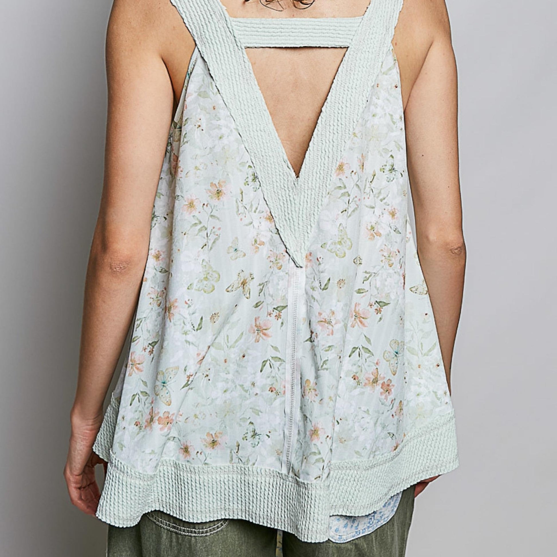 Back view of the POL floral tank showing the relaxed silhouette and curved hem.