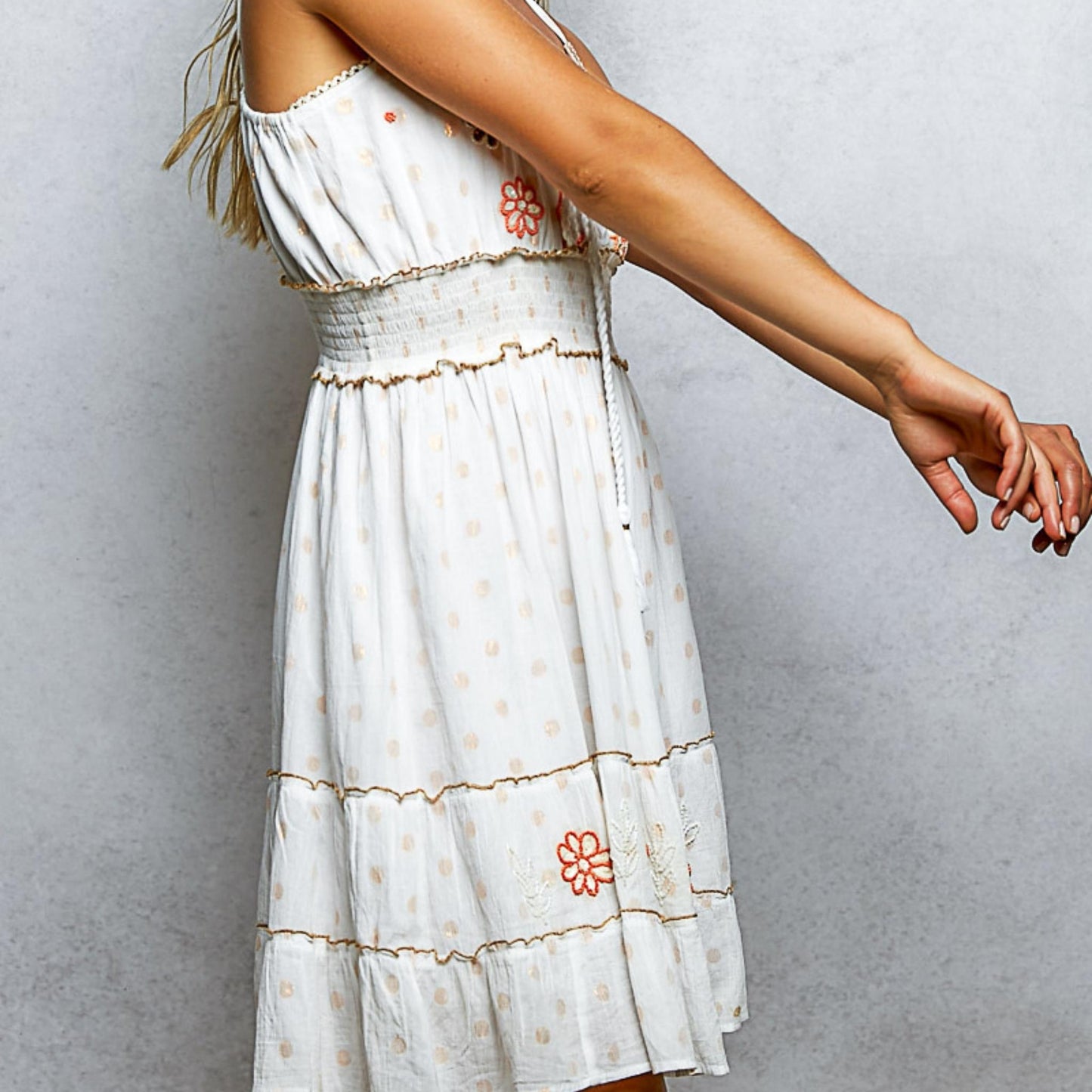 Side perspective of the ivory boho cotton sundress highlighting the embroidery.