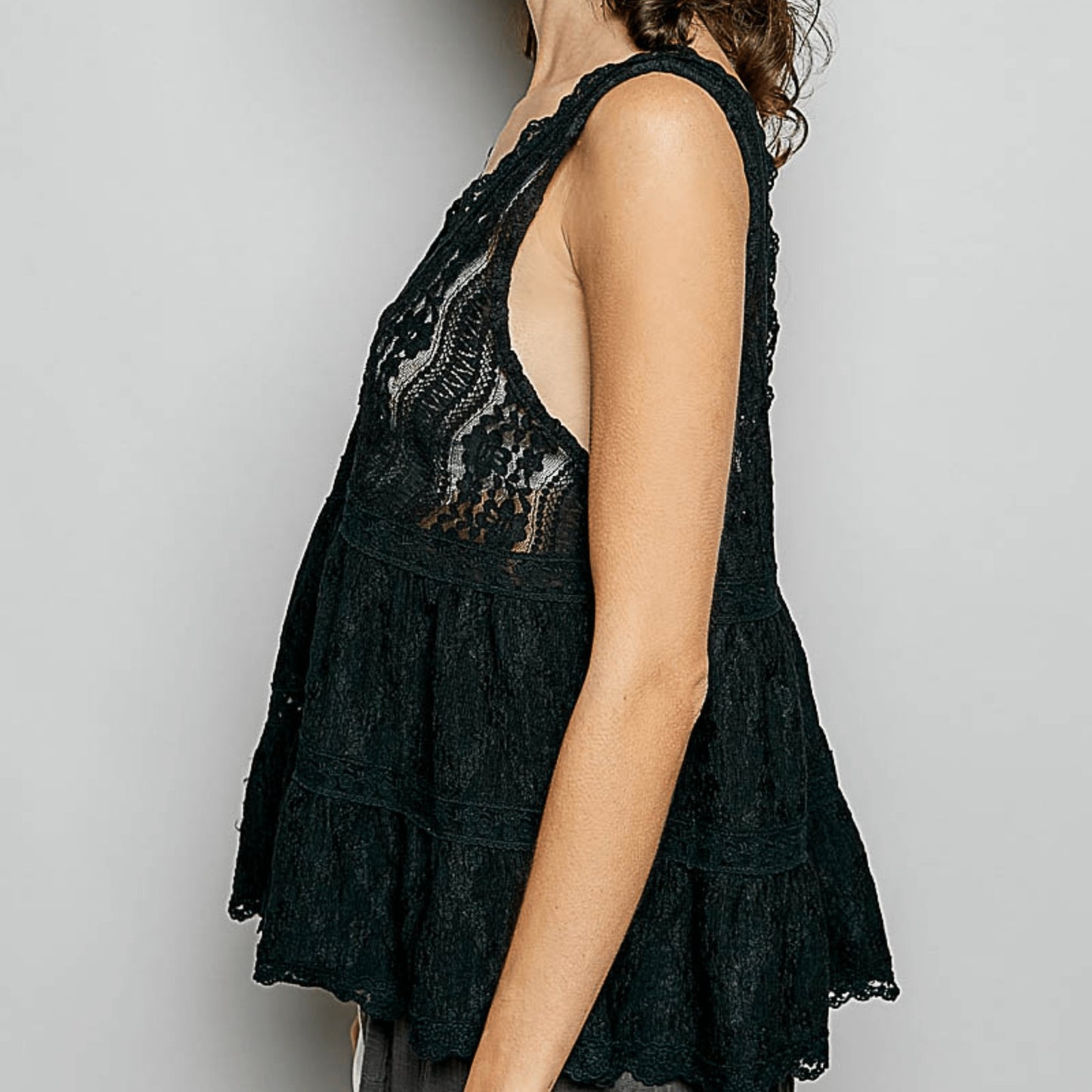 Lateral perspective of the elegant POL black lace top highlighting the flowy fit.