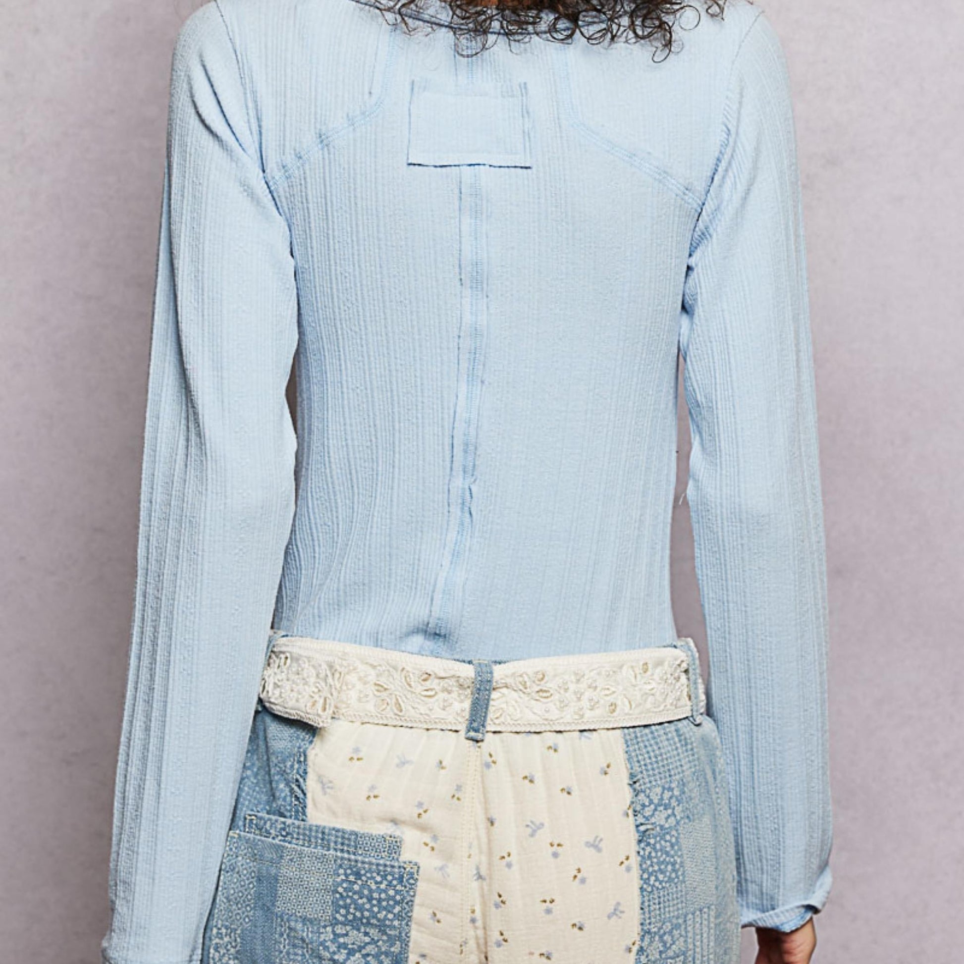 POL powder blue v-neck long sleeve ribbed top with outseam detail — back view.