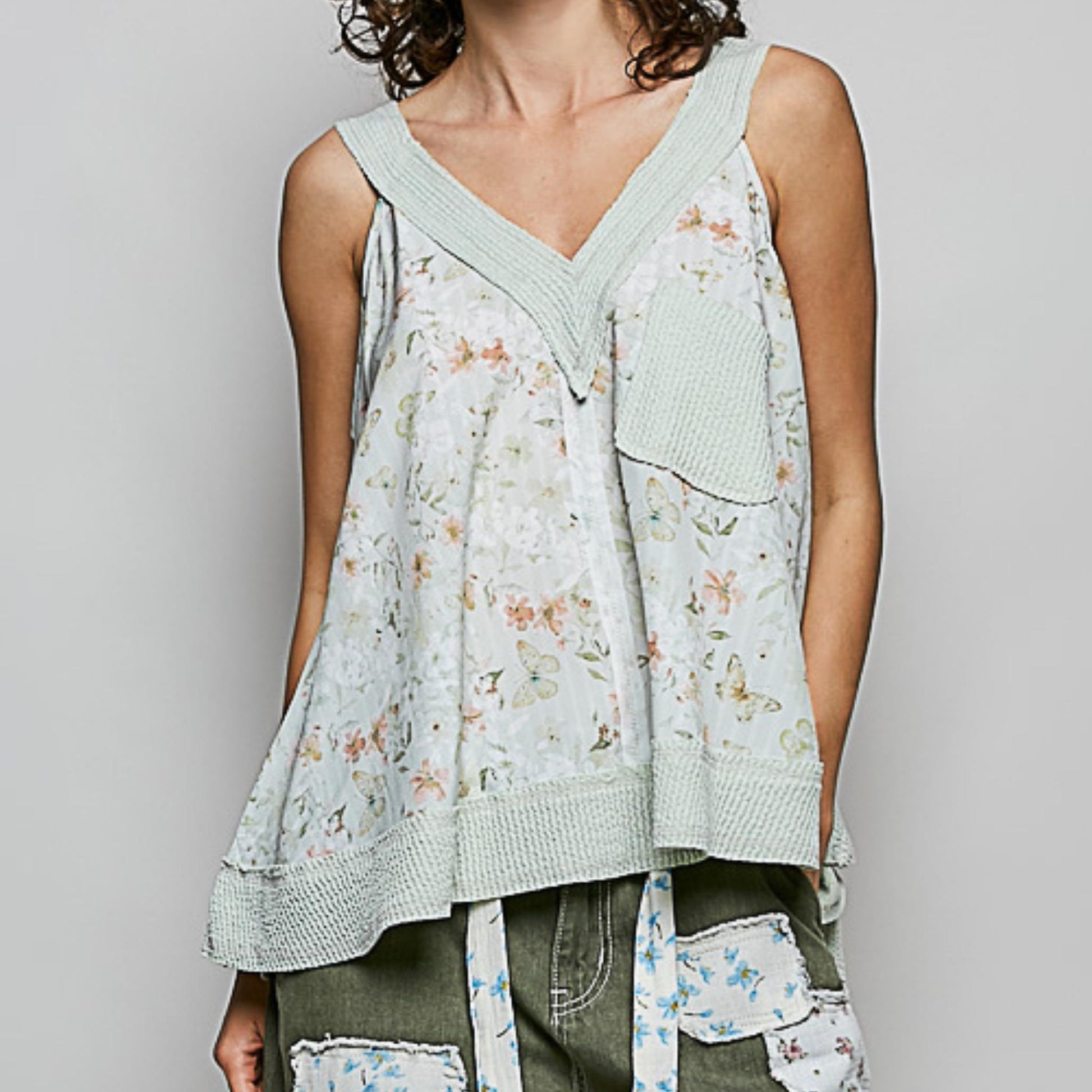 Frontal view of the POL sage floral print sleeveless top.