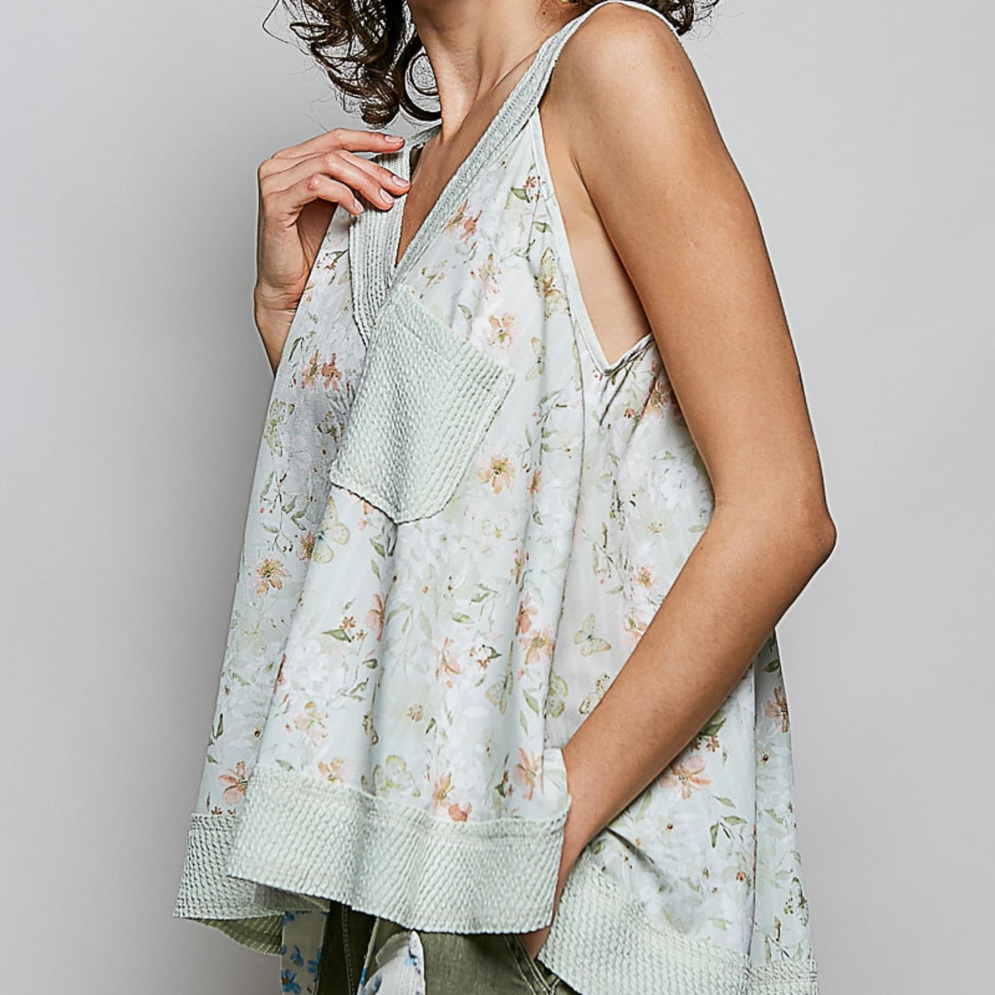 Lifestyle shot of the POL floral V-neck tank in sage multi.