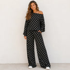 Woman wearing a black polka dot off-the-shoulder top and wide-leg pants set