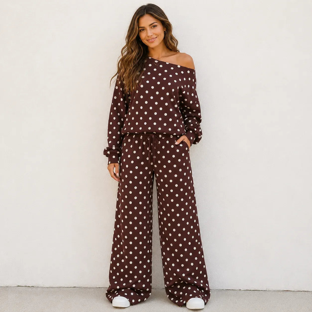 Woman wearing a coffee brown polka dot off-the-shoulder top and wide-leg pants set