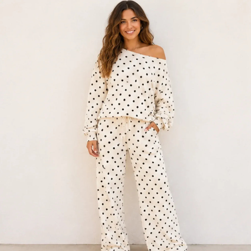 Woman wearing a white polka dot off-the-shoulder top and wide-leg pants set