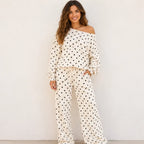 Woman wearing a white polka dot off-the-shoulder top and wide-leg pants set