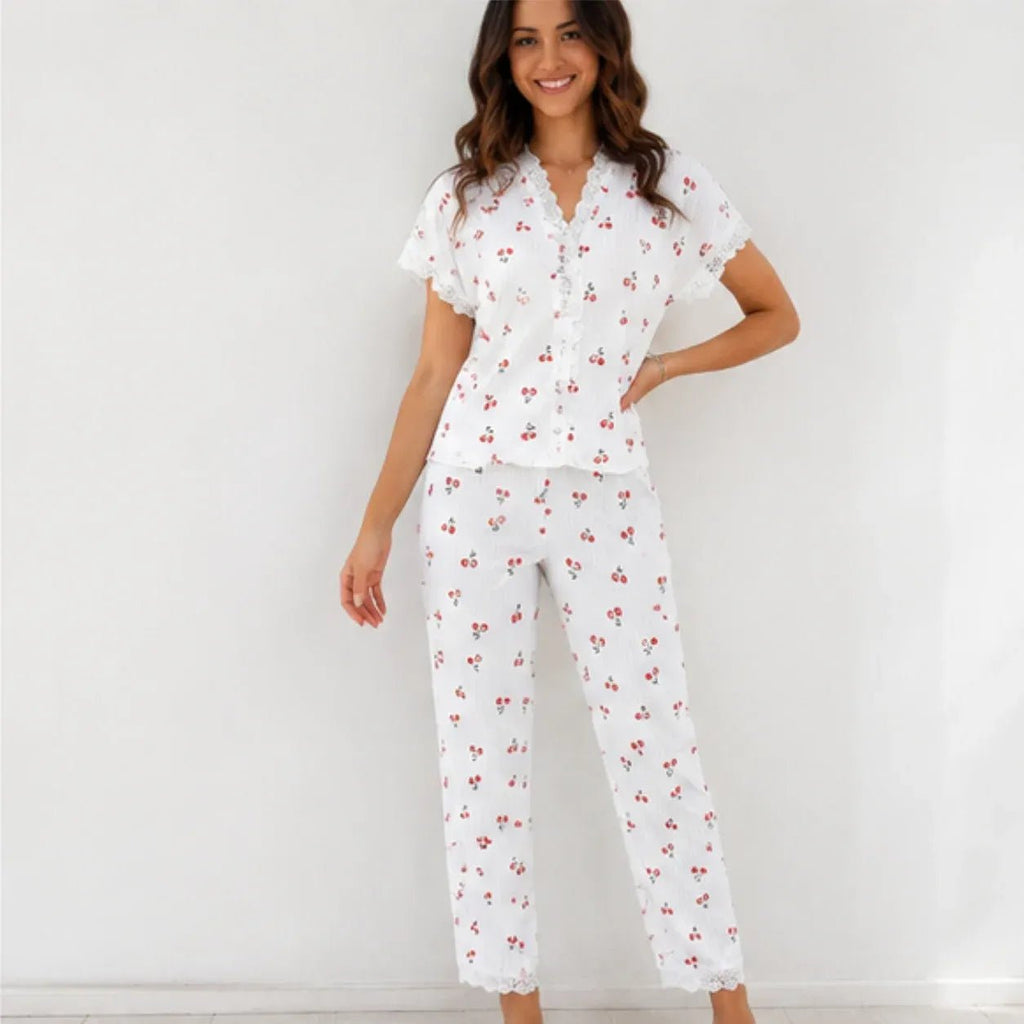 Woman wearing white cherry print lace trim pajama set, front view