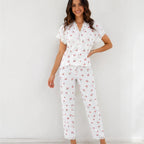 Woman wearing white cherry print lace trim pajama set, front view