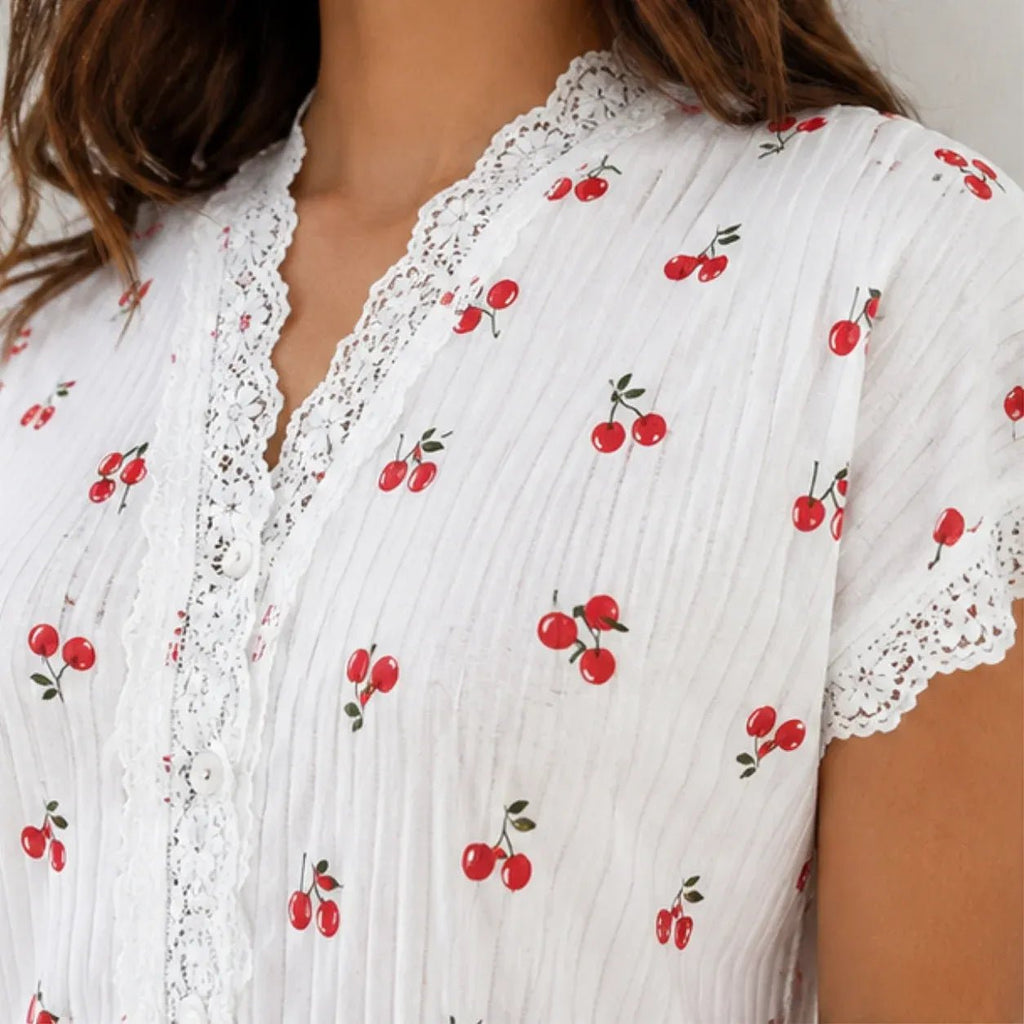 Close-up of white cherry print pajama set with lace trim detailing