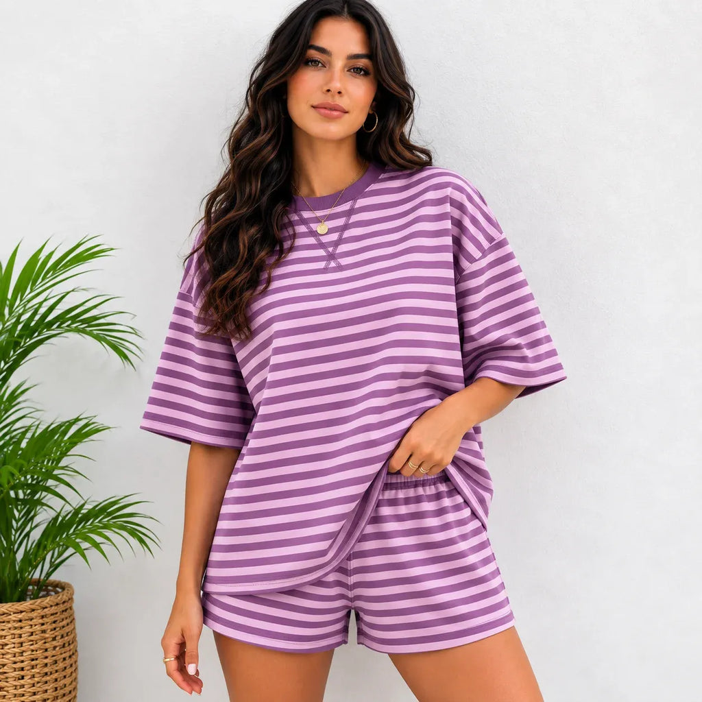 Woman wearing purple and light lavender horizontal striped short-sleeve oversized top and shorts lounge set