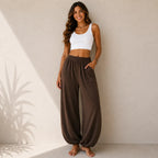 Women's relaxed wide leg cotton pants in brown featuring oversized patch pockets and a relaxed full-length silhouette.