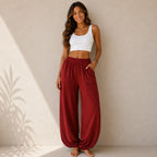 Women's relaxed wide leg cotton pants in burgundy with elastic waistband and comfortable loose fit.