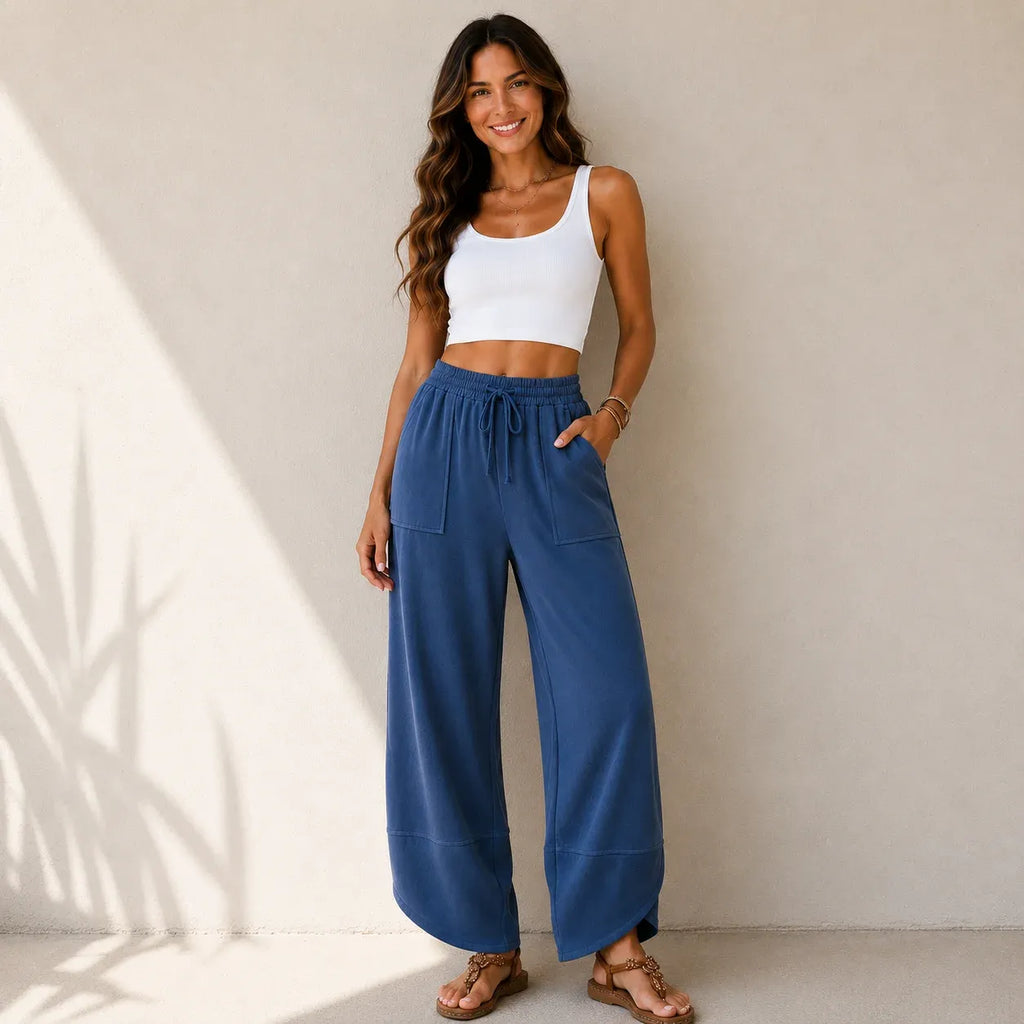Women's relaxed wide leg cotton pants in dusty blue with oversized patch pockets and elastic waistband.