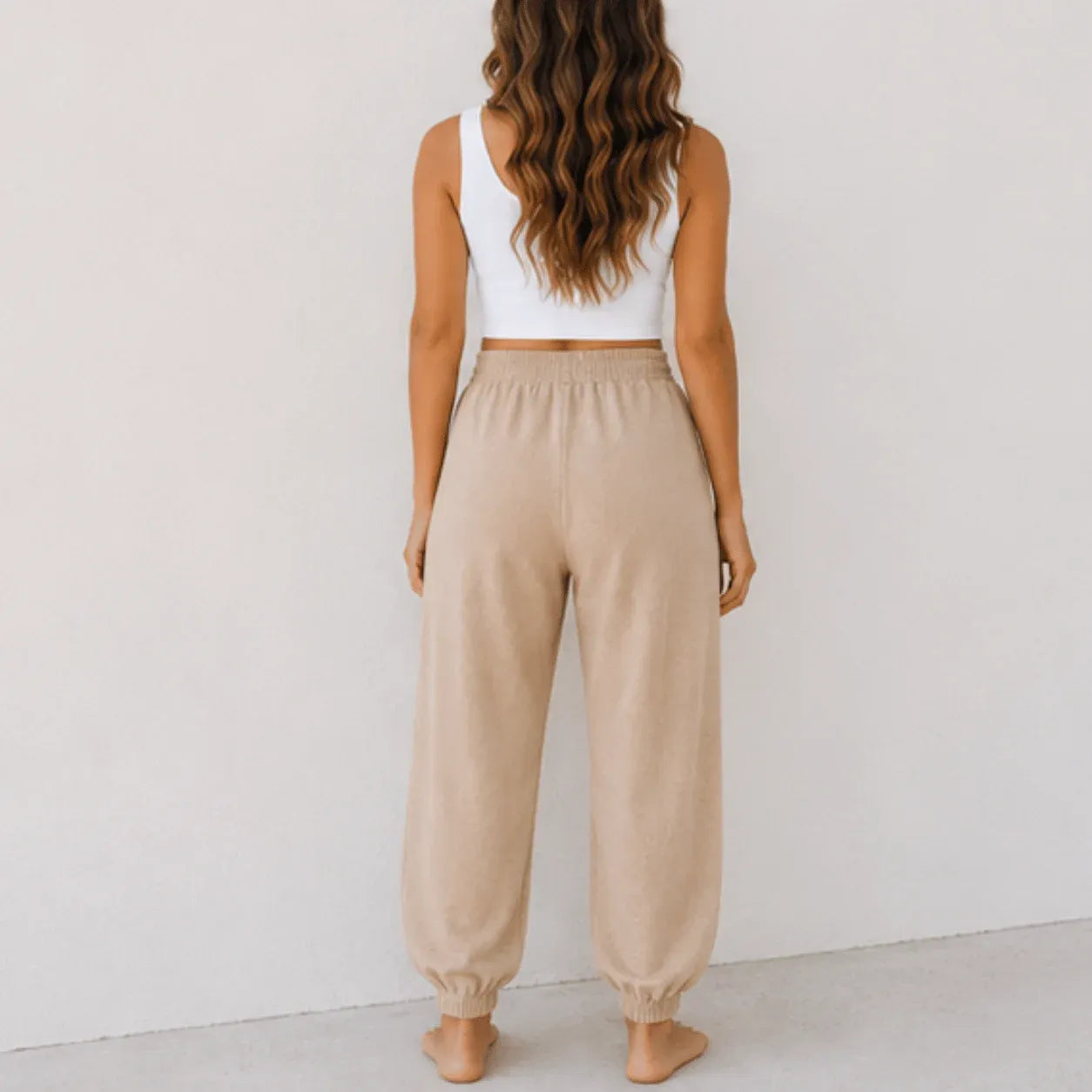 Back view of women's relaxed wide leg khaki cotton pants with a comfortable elastic waistband and relaxed fit.