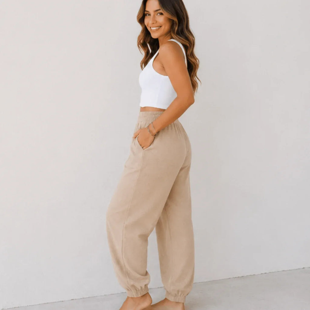 Side view of women's relaxed wide leg khaki cotton pants with elastic waist, oversized fit, and front patch pockets.