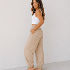 Side view of women's relaxed wide leg khaki cotton pants with elastic waist, oversized fit, and front patch pockets.