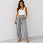 Women's relaxed wide leg cotton pants in light grey with elastic waistband and front patch pockets.