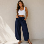 Women's relaxed wide leg cotton pants in navy blue with elastic waist and loose, flowy silhouette.
