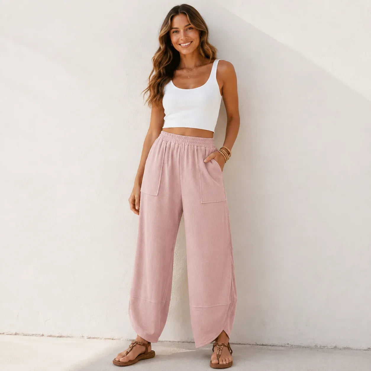 Women's relaxed wide leg cotton pants in soft pink with oversized patch pockets and a comfortable fit.