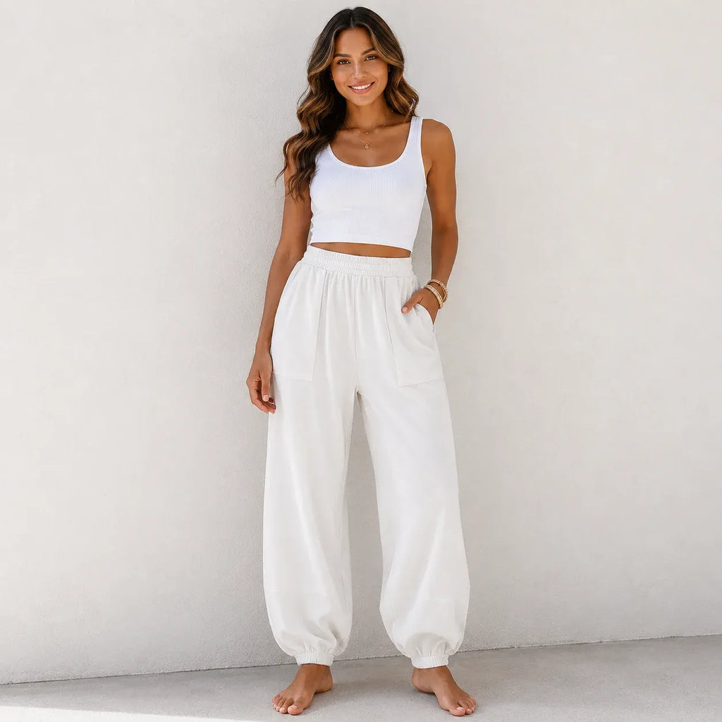 Women's relaxed wide leg cotton pants in white featuring a loose fit and comfortable elastic waist.