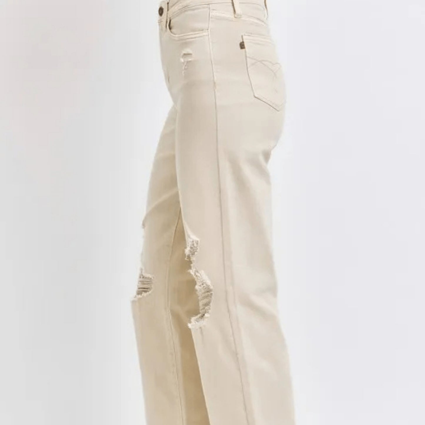 Side view of a person wearing bone-colored wide-leg jeans.