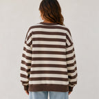 Back view of the women's retro striped crew neck sweatshirt in coffee stripes with a loose fit, soft sweatshirt fabric, and ribbed hem and cuffs.