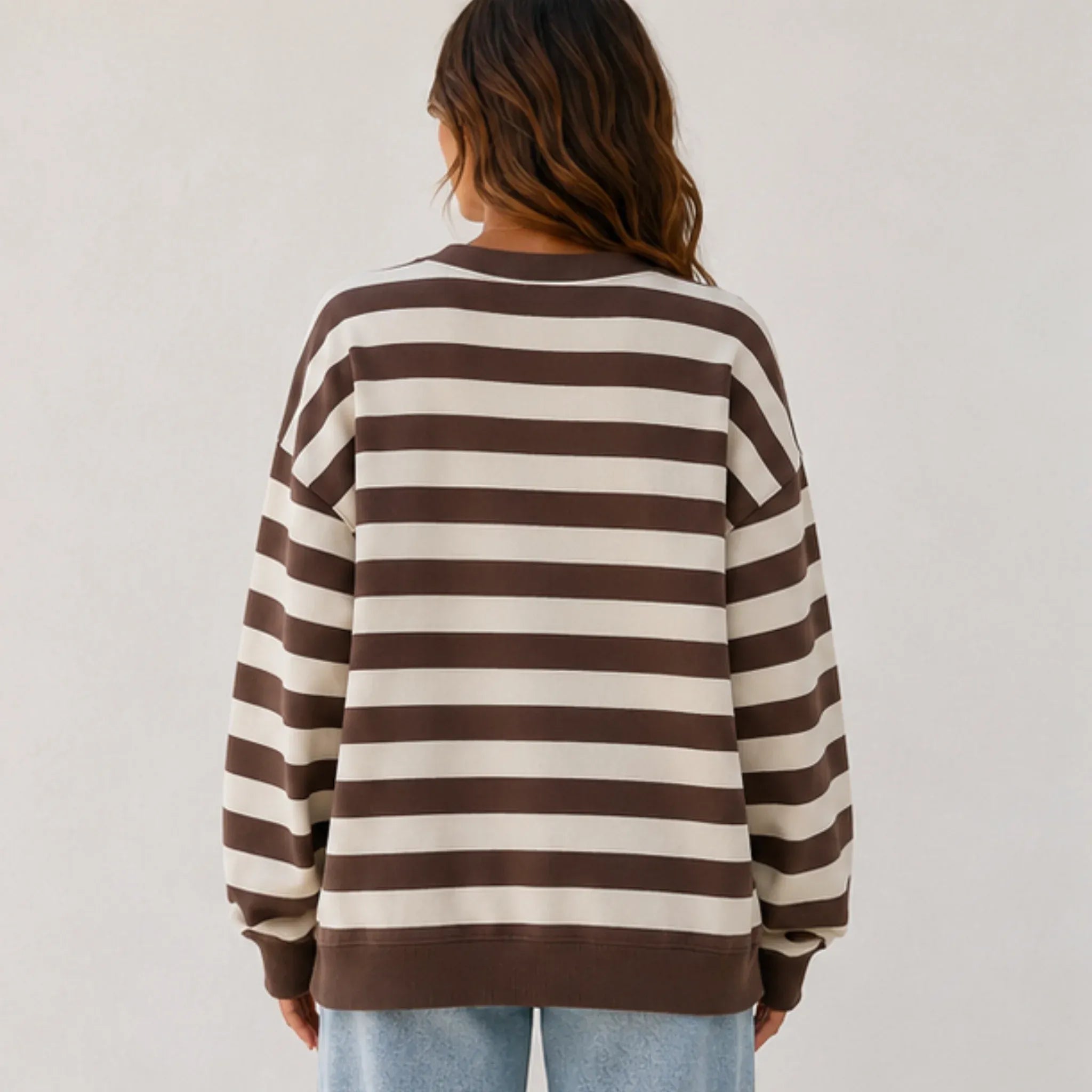 Back view of the women's retro striped crew neck sweatshirt in coffee stripes with a loose fit, soft sweatshirt fabric, and ribbed hem and cuffs.