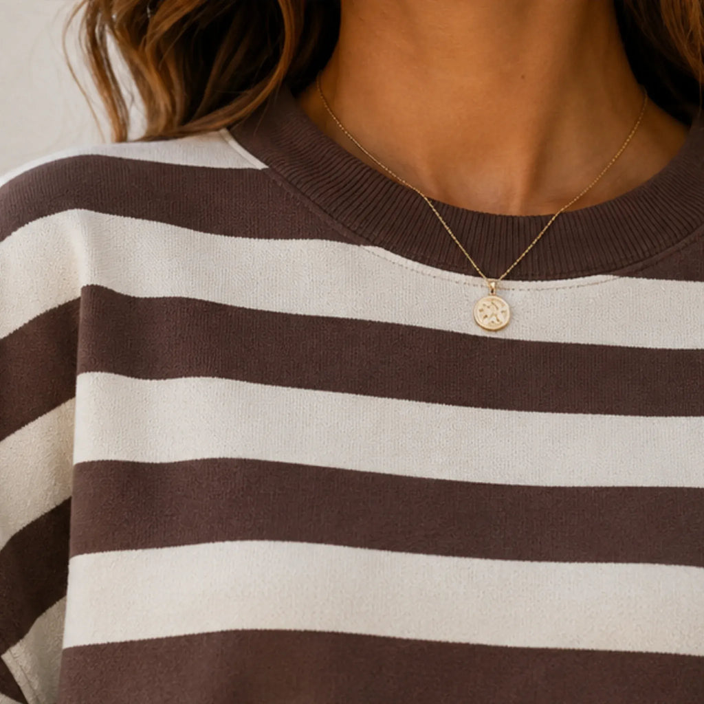 Close-up of the women's retro striped crew neck sweatshirt in coffee stripes highlighting the ribbed crew neckline and soft brushed sweatshirt knit fabric.