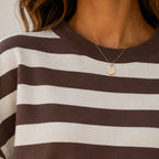 Close-up of the women's retro striped crew neck sweatshirt in coffee stripes highlighting the ribbed crew neckline and soft brushed sweatshirt knit fabric.