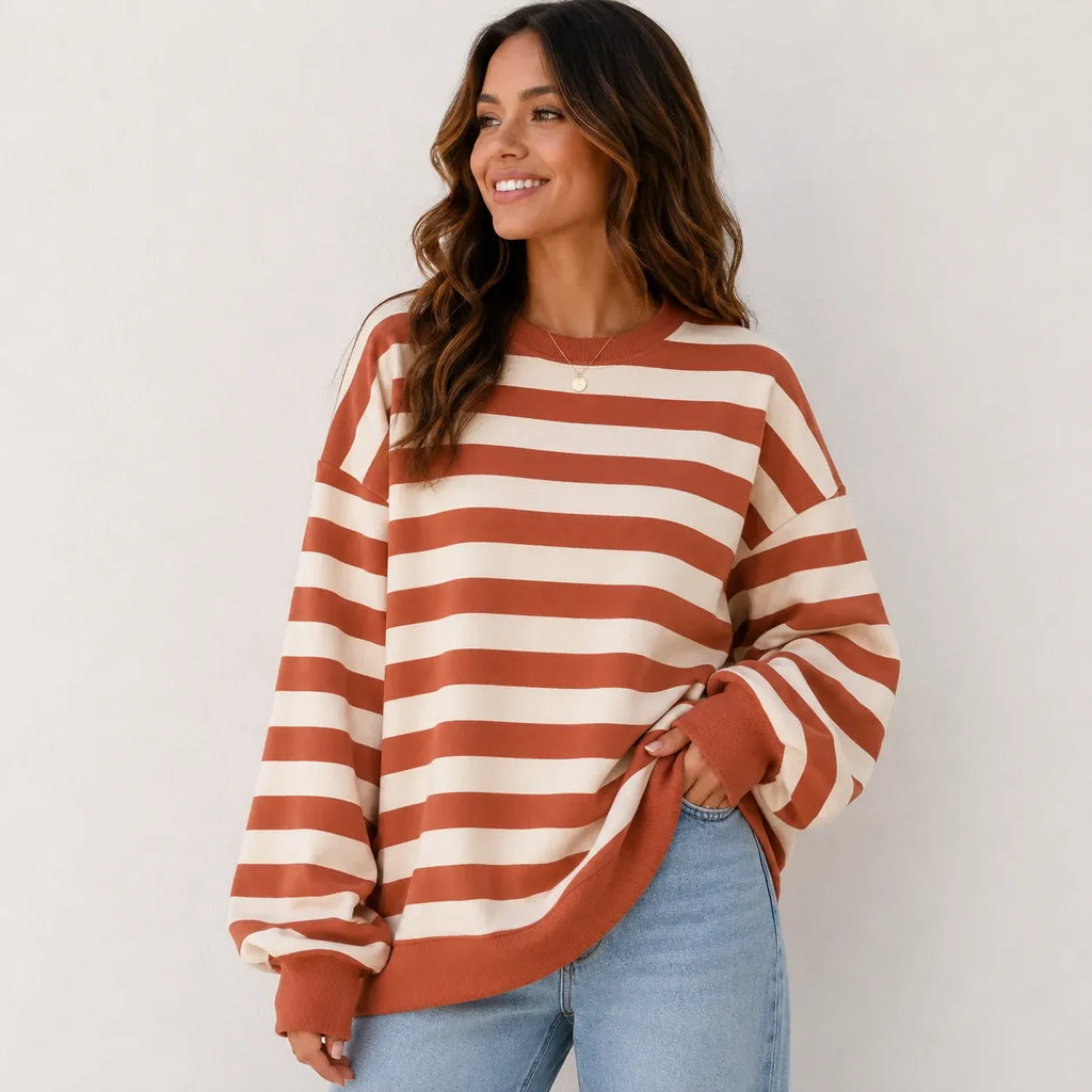 Women's retro striped crew neck sweatshirt in pink stripes featuring a relaxed oversized fit, soft brushed sweatshirt knit, long sleeves, and ribbed cuffs.