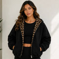 Reversible leopard hooded jacket in black, front view with leopard print lining
