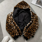 Reversible leopard hooded jacket displayed flat showing leopard print exterior and black interior