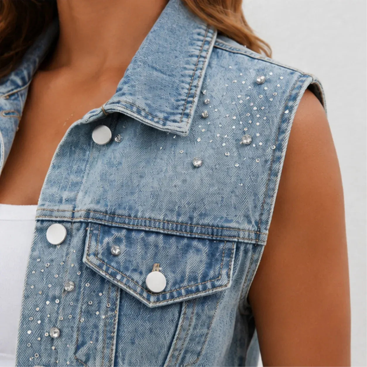 Close-up of rhinestone embellishments on blue denim vest