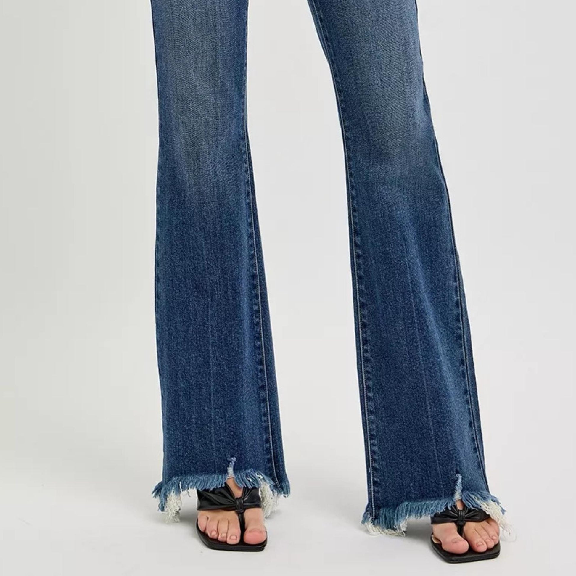 Close-up of the dark wash denim texture and stitching on RISEN jeans.