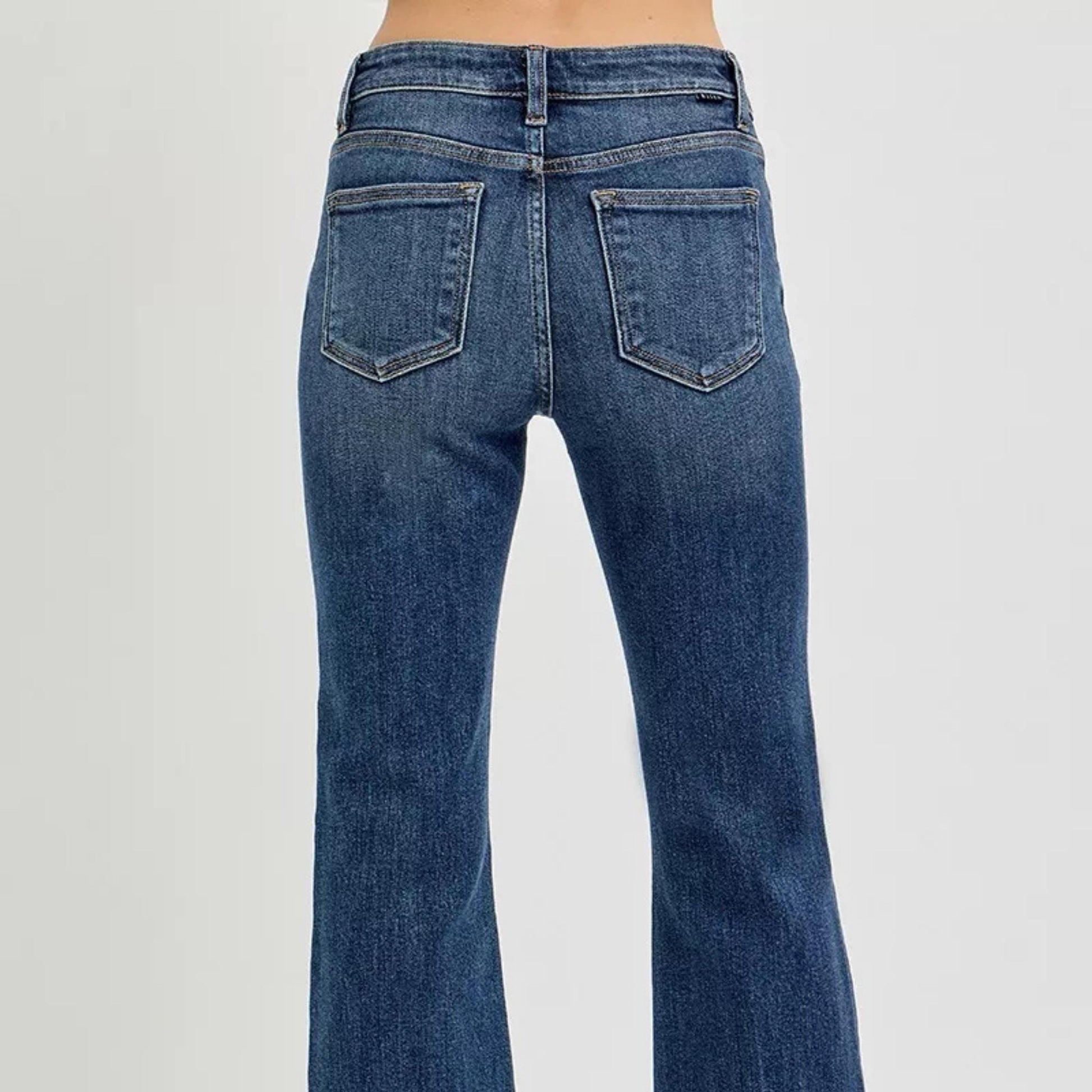 Back view of RISEN dark wash flare jeans showing pocket placement.