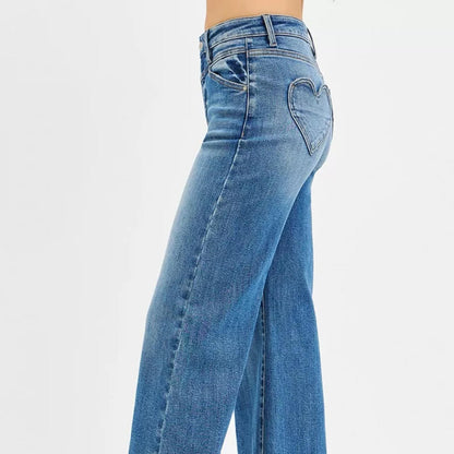 Side view of RISEN medium wash wide-leg denim showing the front yoke detail.