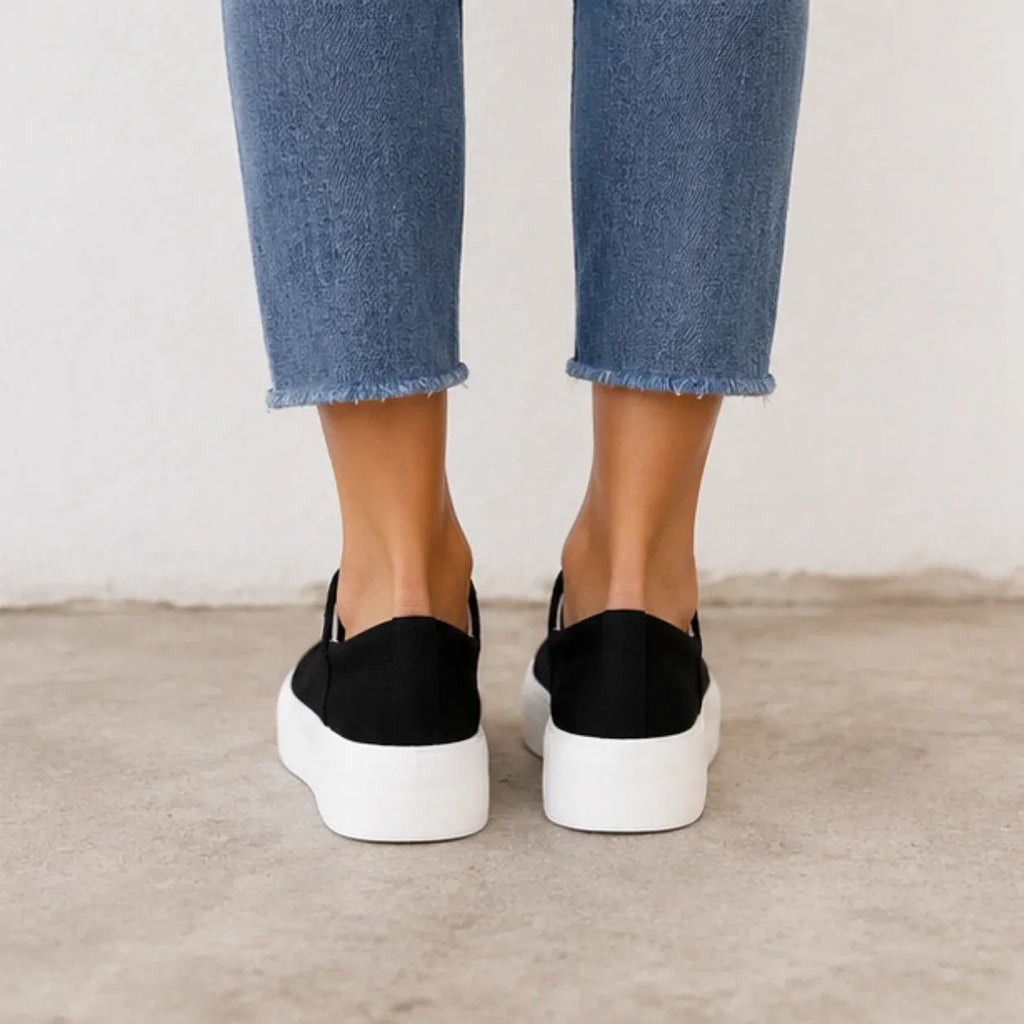 Back view of the black Roam Wild Convertible Sneakers featuring a chunky white platform sole.