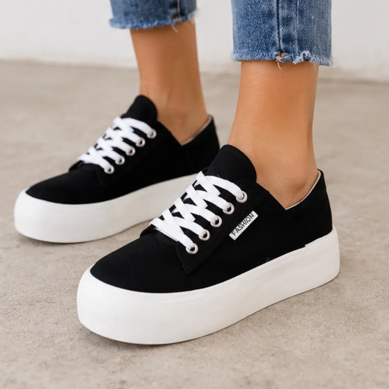 Close-up of the black Roam Wild Convertible Sneakers highlighting the lace-up design and cushioned platform sole.