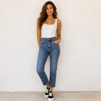 Woman wearing Roam Wild Convertible Sneakers in black with a white platform sole, styled with blue jeans and a white tank top.