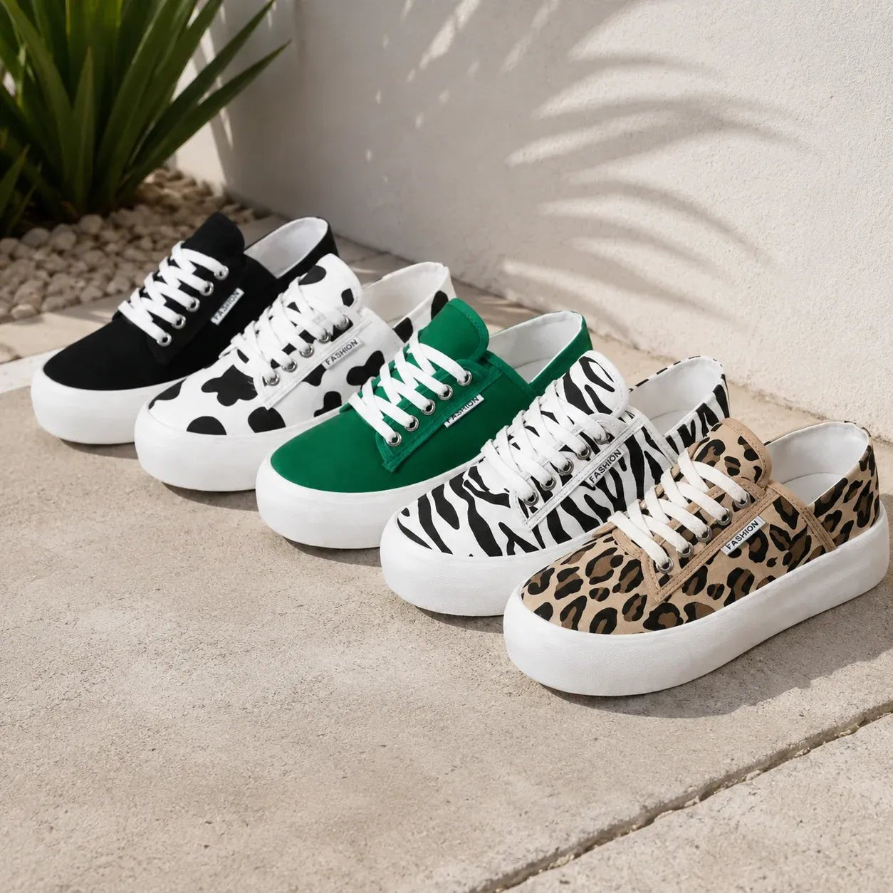 Roam Wild Convertible Sneakers color collection featuring black, cow print, green, zebra print, and leopard print lace-up platform sneakers with chunky white soles.