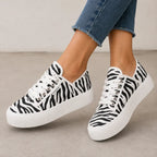 Zebra print Roam Wild Convertible Sneakers with bold black and white stripes and a chunky platform sole.