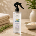 Rosemary and rice water hair spray 200ml displayed with rosemary, rice and neutral spa-inspired decor