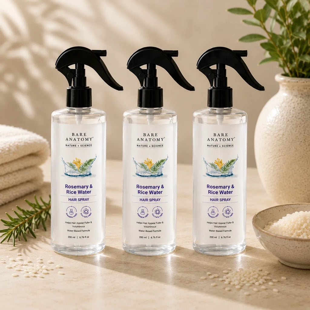 Three bottles of rosemary and rice water hair spray displayed together with rosemary and rice