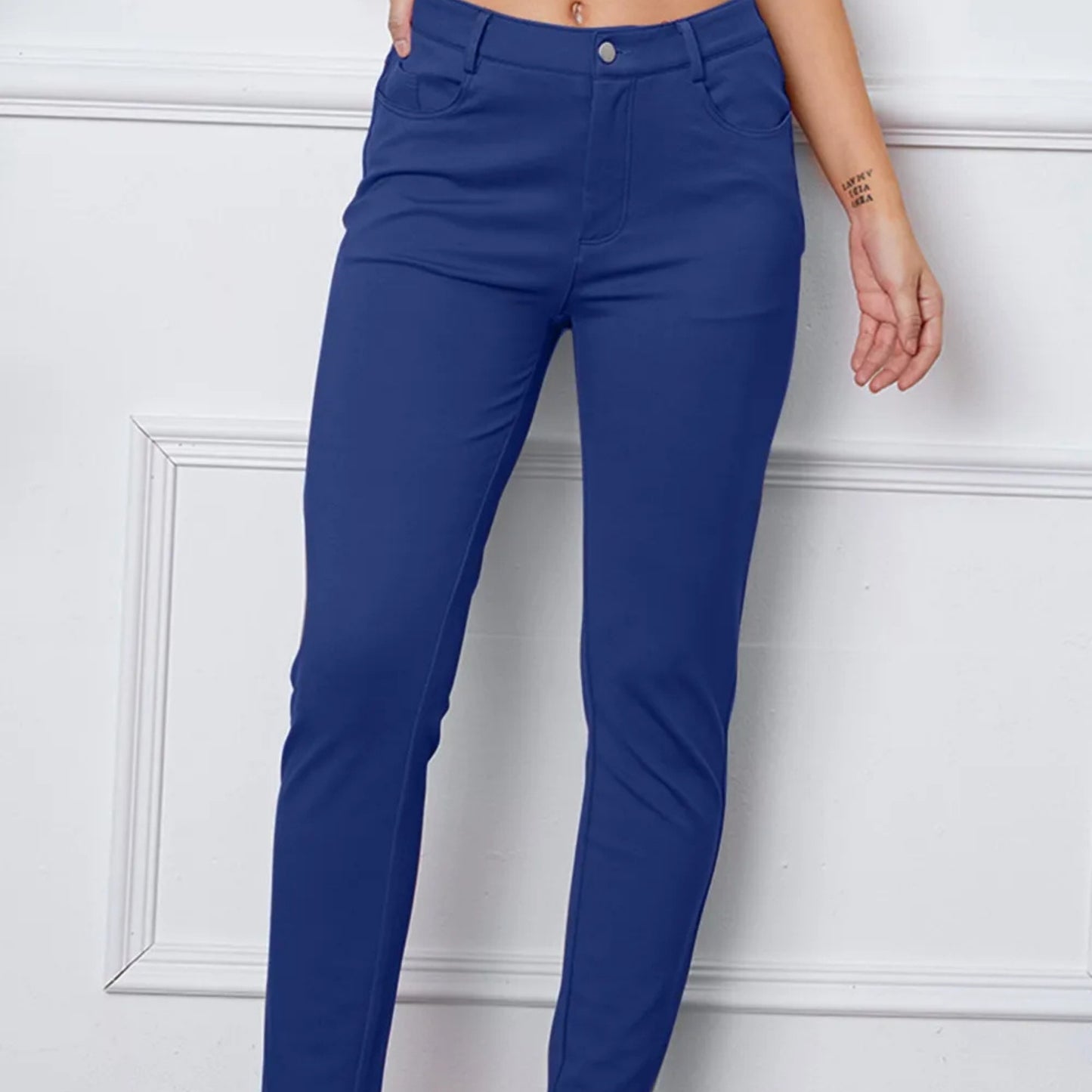 Royal Blue pants worn by a person against a white wall