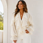 Women's white ruffle chiffon long sleeve blouse with cascading layered ruffles, sheer sleeves, V-neckline, and elegant lightweight fabric.