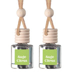 Two reed diffuser bottles with clear glass bodies, light wood stoppers, and natural woven cords, each with a green label reading 'Sage Citrus' on a white background.