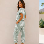 Side view of a women's sage green tie-dye lounge set featuring a relaxed fit and jogger pants.