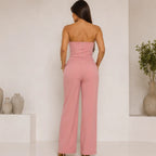 Women's Sculpted Grace two-piece set in dusty pink featuring a strapless peplum top with back zipper closure and matching wide-leg pants, back view.