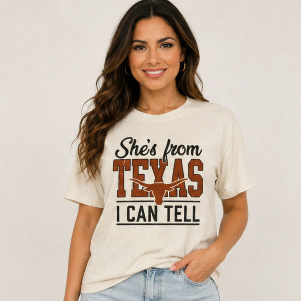 Woman wearing She's From Texas I Can Tell country graphic T-shirt with longhorn design at Solazura Boutique